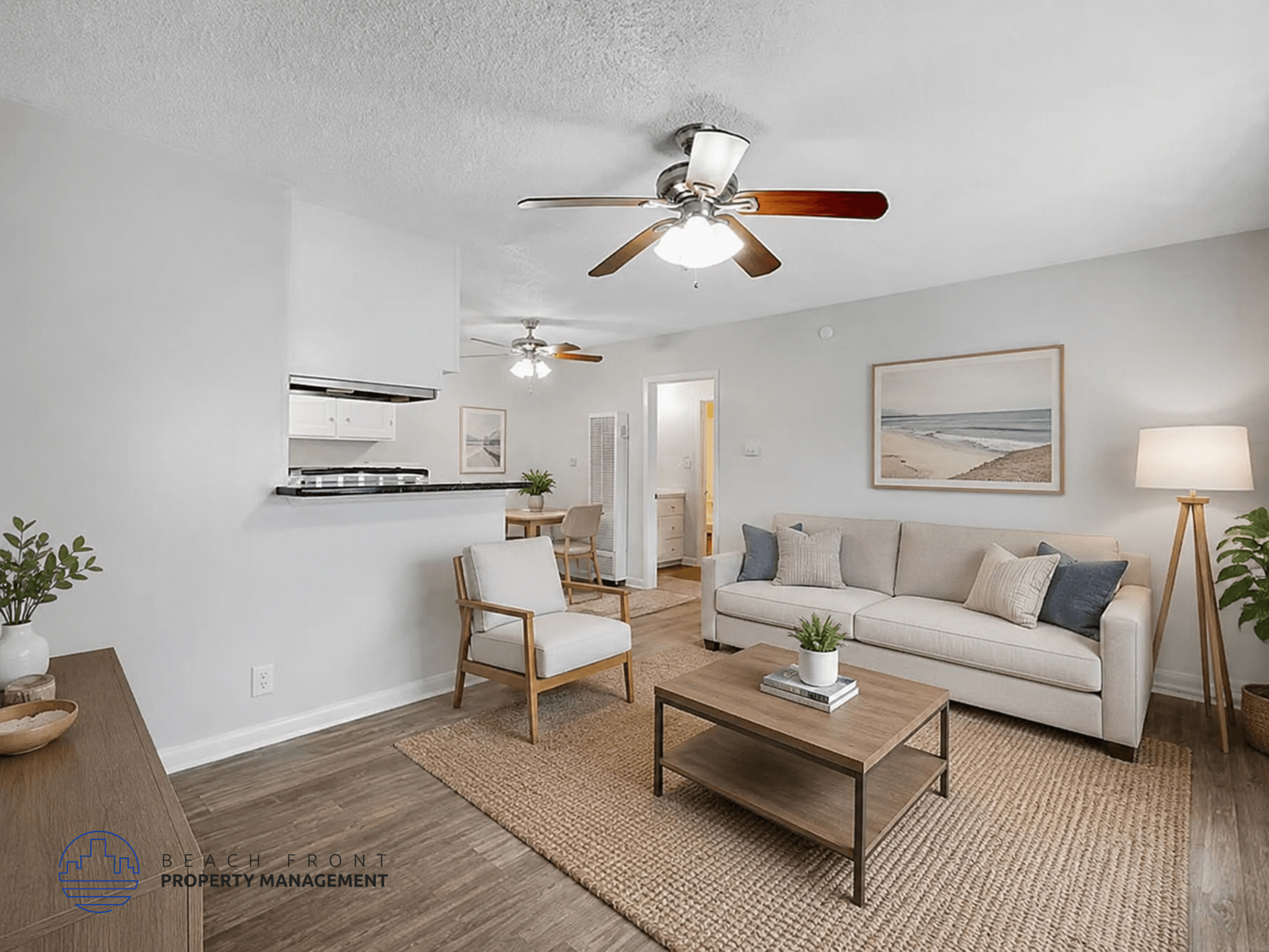 A living room with a ceiling fan, a couch, a chair, and a coffee table.